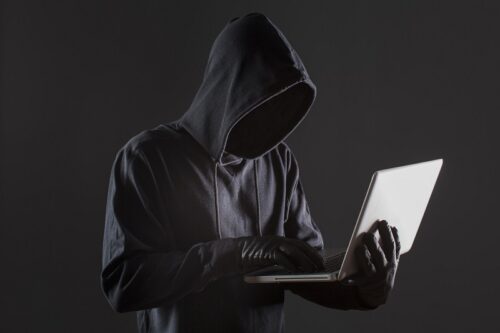 side-view-male-hacker-with-gloves-laptop (1)